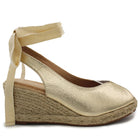 Soraia shoes. Wedge of jute and synthetic leather or anelline with bow trim and elastic fit to the ankle. Women's sandals. PlatiNum
