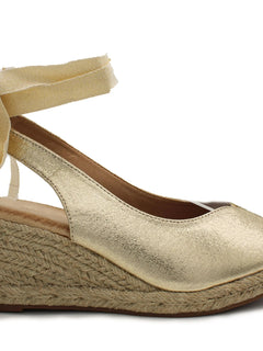 Soraia shoes. Wedge of jute and synthetic leather or anelline with bow trim and elastic fit to the ankle. Women's sandals.