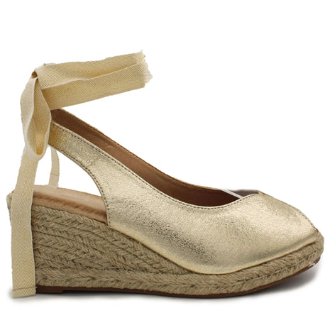 Soraia shoes. Wedge of jute and synthetic leather or anelline with bow trim and elastic fit to the ankle. Women's sandals. PlatiNum