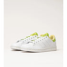 Adidas Stan Smith Disney Tiana and the Frog limited edition women's sneakers, featuring a classic white upper with green accents, comfortable lightweight cushioning, and a sustainable sole made from recycled materials. PlatiNum
