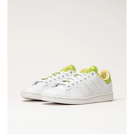 Adidas Stan Smith Disney Tiana and the Frog limited edition women's sneakers, featuring a classic white upper with green accents, comfortable lightweight cushioning, and a sustainable sole made from recycled materials. PlatiNum