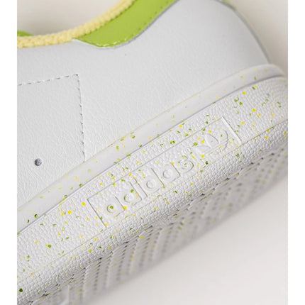 Adidas Stan Smith Disney Tiana and the Frog limited edition women's sneakers, featuring a classic white upper with green accents, comfortable lightweight cushioning, and a sustainable sole made from recycled materials. PlatiNum
