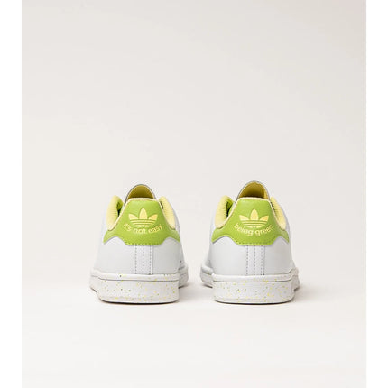 Adidas Stan Smith Disney Tiana and the Frog limited edition women's sneakers, featuring a classic white upper with green accents, comfortable lightweight cushioning, and a sustainable sole made from recycled materials. PlatiNum