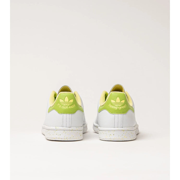 Adidas Stan Smith Disney Tiana and the Frog limited edition women's sneakers, featuring a classic white upper with green accents, comfortable lightweight cushioning, and a sustainable sole made from recycled materials. PlatiNum