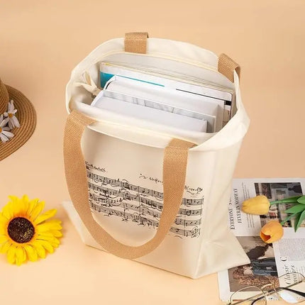 Borsa tote con cerniera dal design ispirato a Mozart e alle partiture di musica classica. Ampia capacità e design compatto.