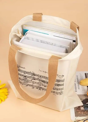 Borsa tote con cerniera dal design ispirato a Mozart e alle partiture di musica classica. Ampia capacità e design compatto.