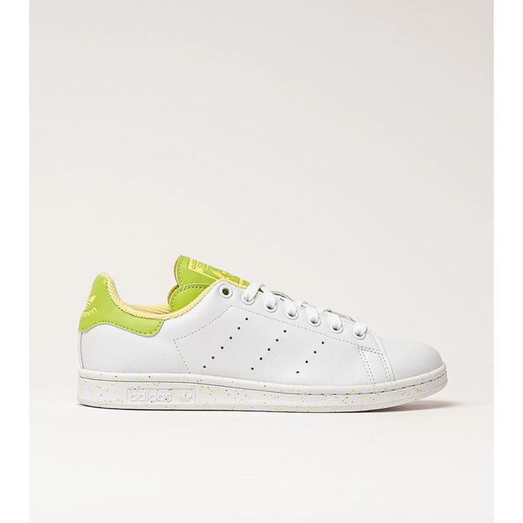 Adidas Stan Smith Disney Tiana and the Frog limited edition women's sneakers, featuring a classic white upper with green accents, comfortable lightweight cushioning, and a sustainable sole made from recycled materials. PlatiNum