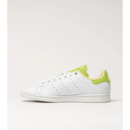 Adidas Stan Smith Disney Tiana and the Frog limited edition women's sneakers, featuring a classic white upper with green accents, comfortable lightweight cushioning, and a sustainable sole made from recycled materials. PlatiNum