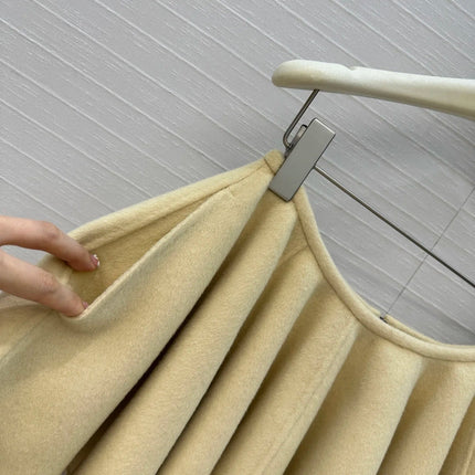 A light yellow high-waisted short skirt with ruffled edges and a double-sided wool A-line skirt, looking cute and playful PlatiNum
