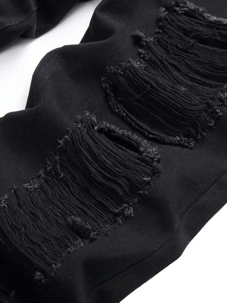 Single piece of trendy streetwear: straight-cut ripped denim jeans in black. PlatiNum