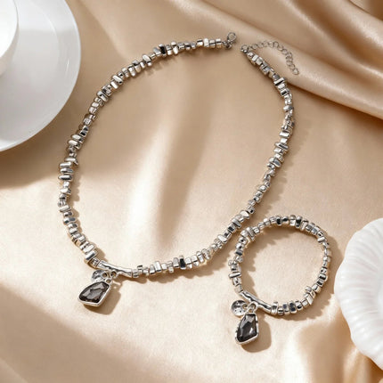 Set di bracciali con collana con pendente in cristallo grigio irregolare semplice barocco Set di gioielli con perline color argento estetico delicato per donna uomo platinumshop