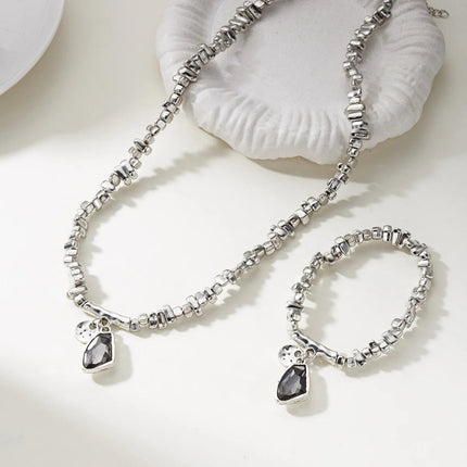 Set di bracciali con collana con pendente in cristallo grigio irregolare semplice barocco Set di gioielli con perline color argento estetico delicato per donna uomo platinumshop